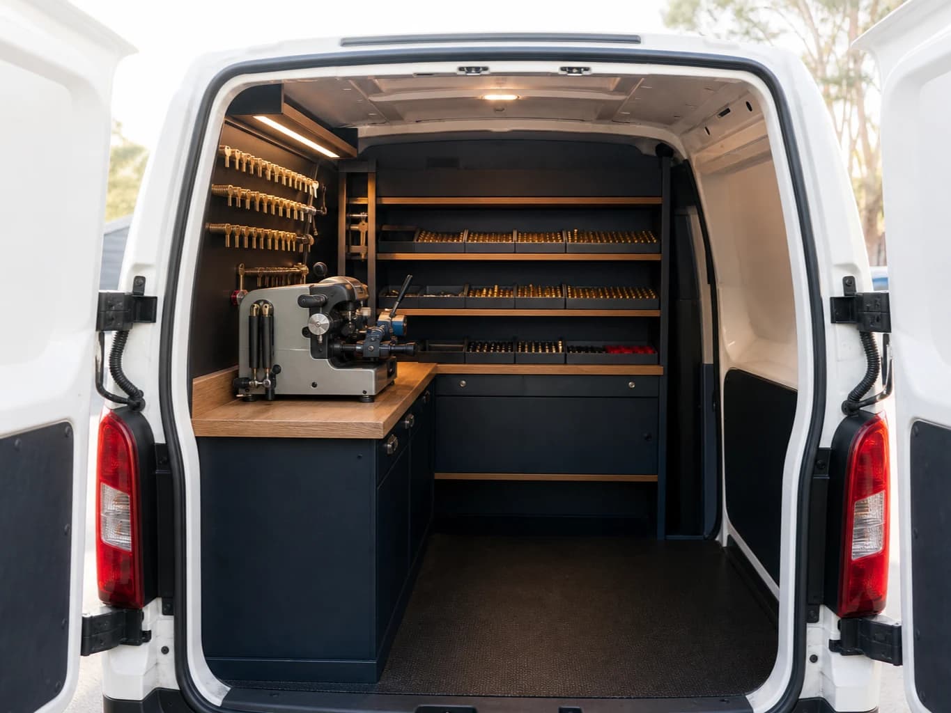 Key cutting and programming equipment in the fitted interior of a locksmith's van